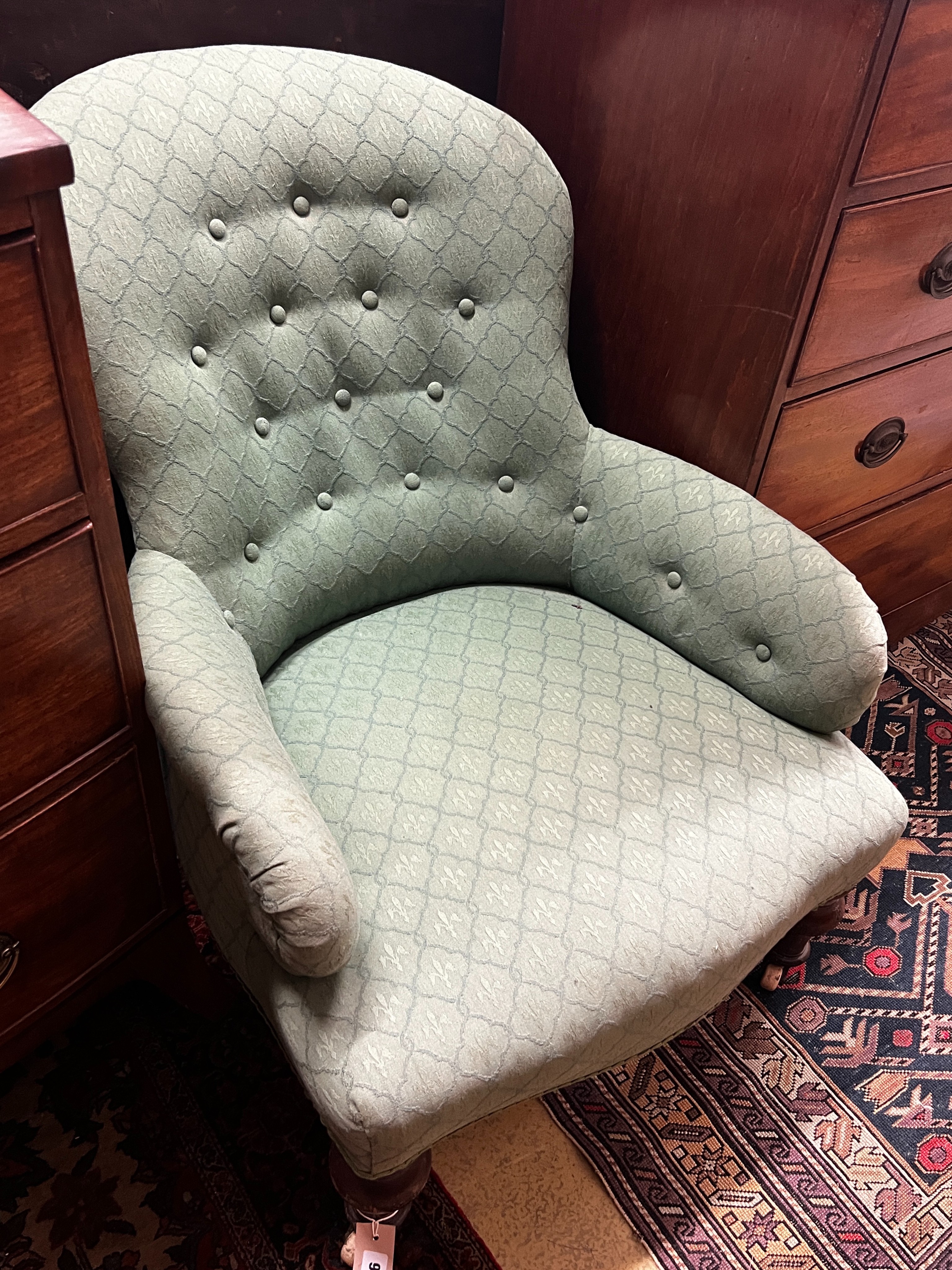 A Victorian upholstered spoon back armchair, width 66cm, depth 84cm, height 79cm